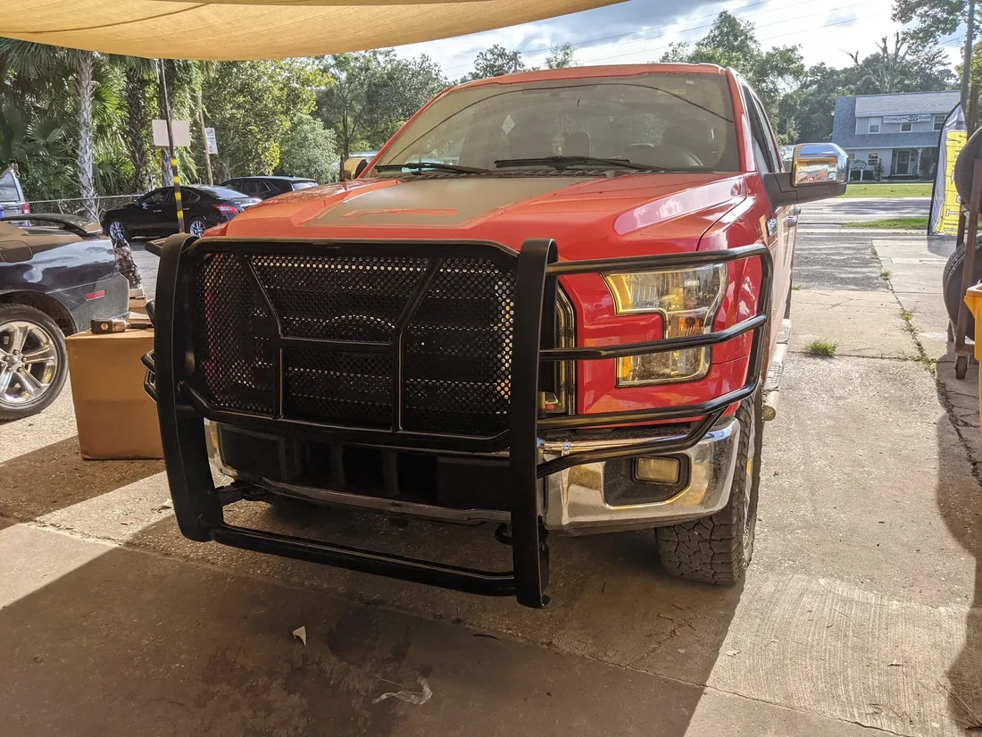 Red Ford with a grille guard at Myhree Motors