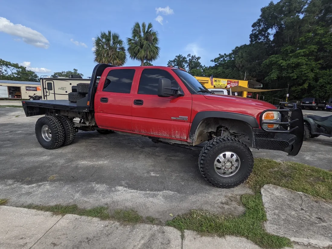 GMC flatbed, lifted, on mud tires at Myhree Motors